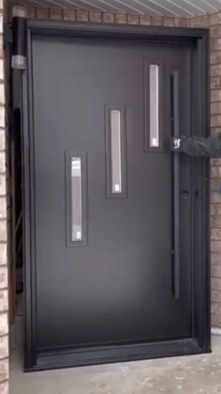 Modern black entry door with staggered glass lites on a brick Oakville home